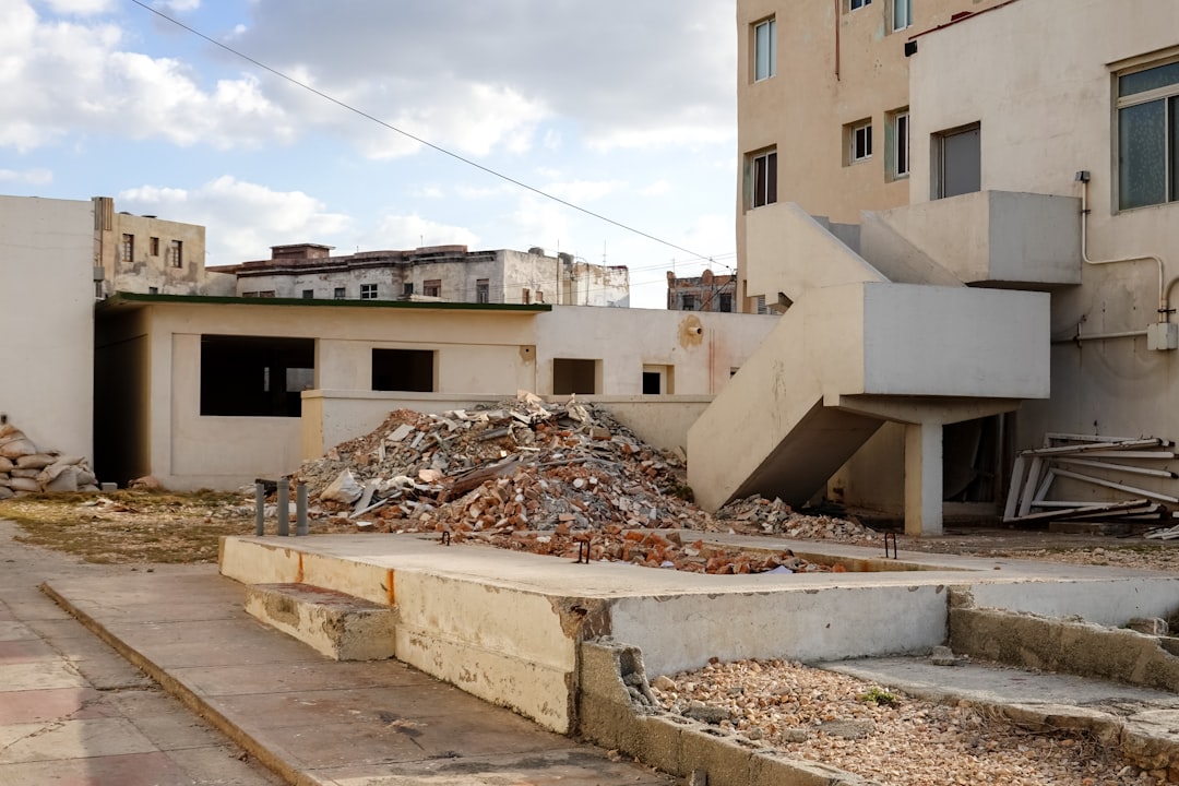 white concrete building under white clouds during daytime