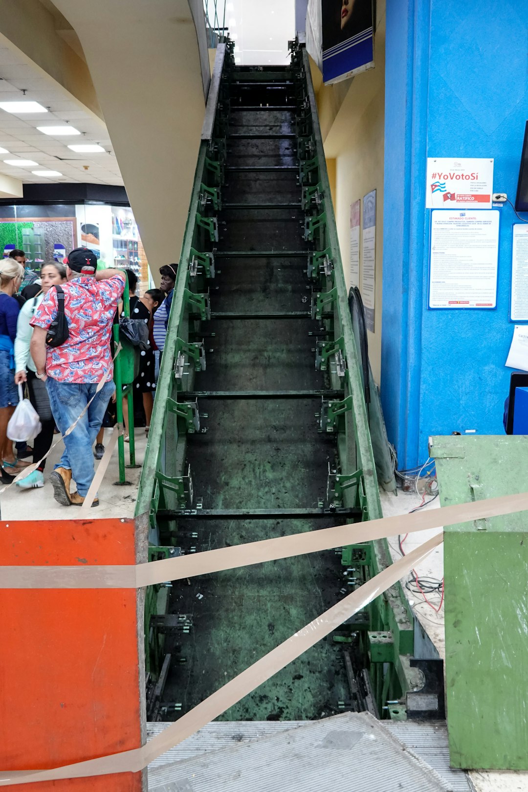 people walking on green metal stairs