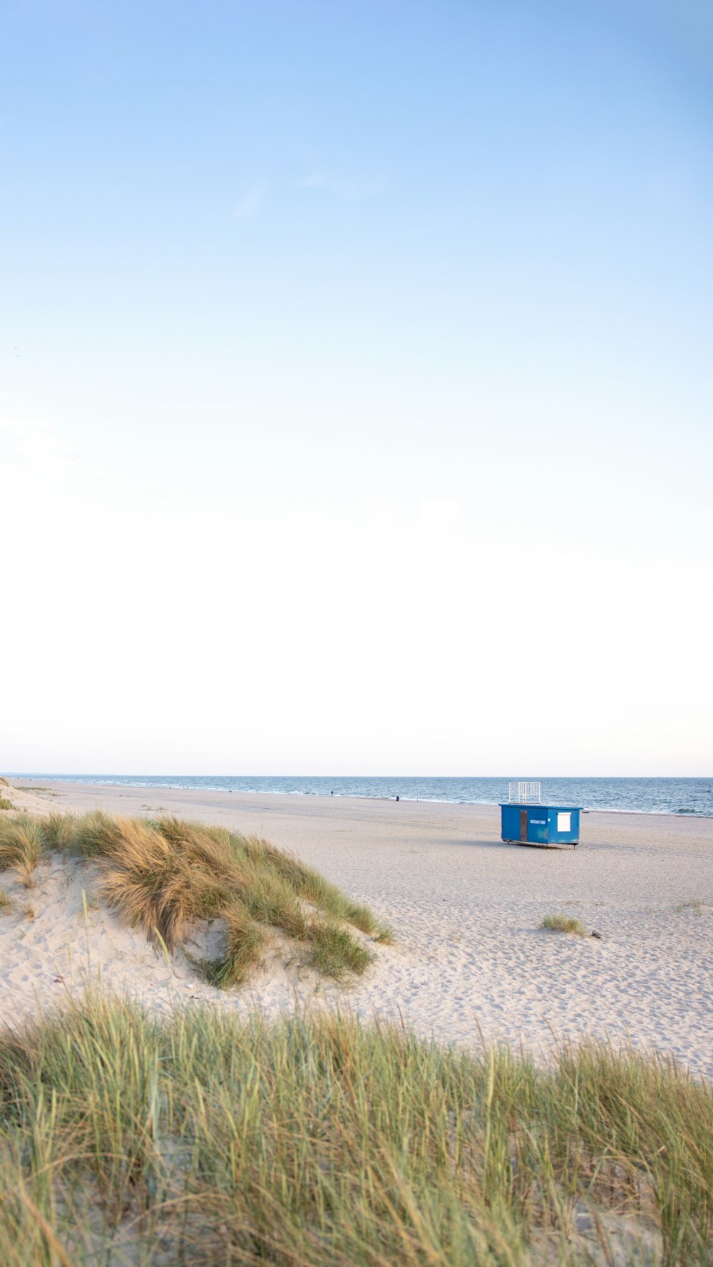 blue and white shed on beach