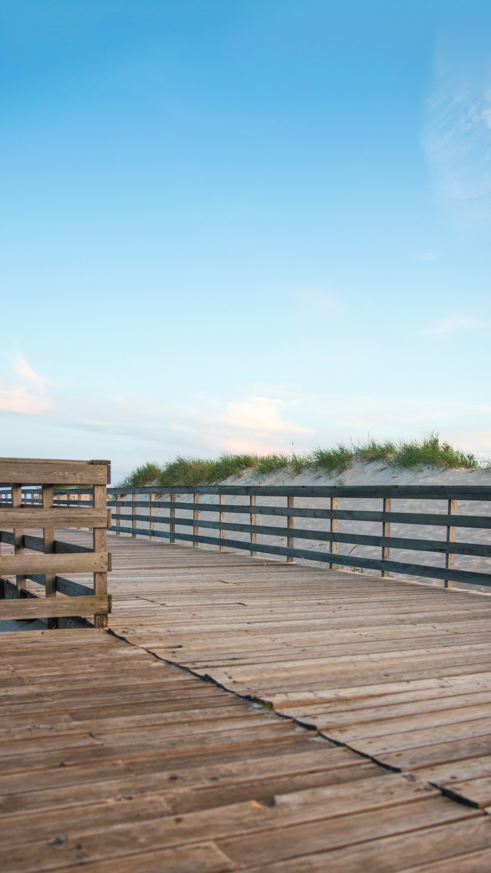 brown wooden fence on brown wooden dock during daytime