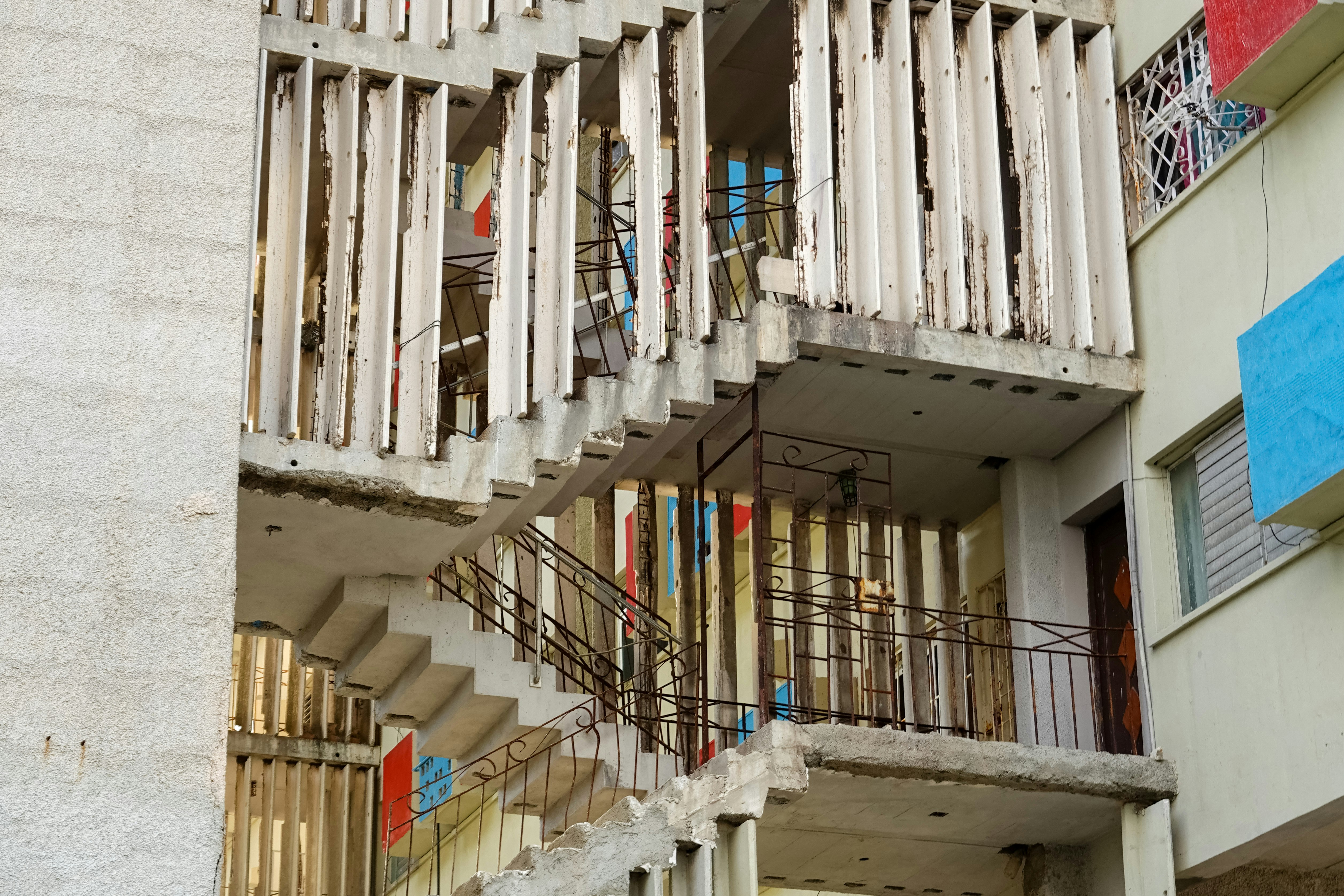 white concrete building with white metal railings