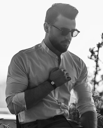 man in dress shirt wearing black sunglasses