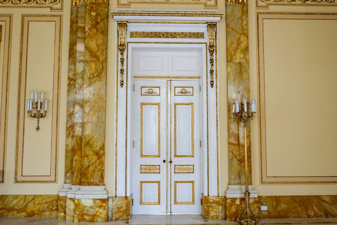 white wooden door with gold door lever