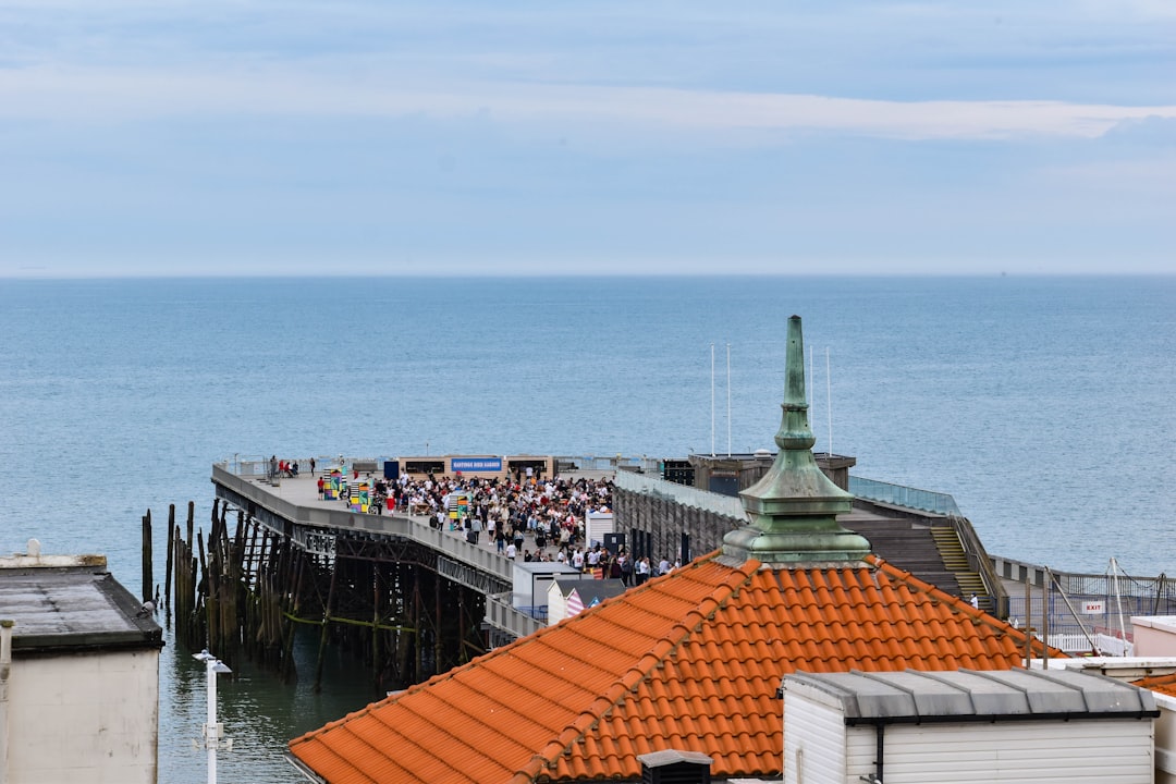 people walking on dock near body of water during daytime