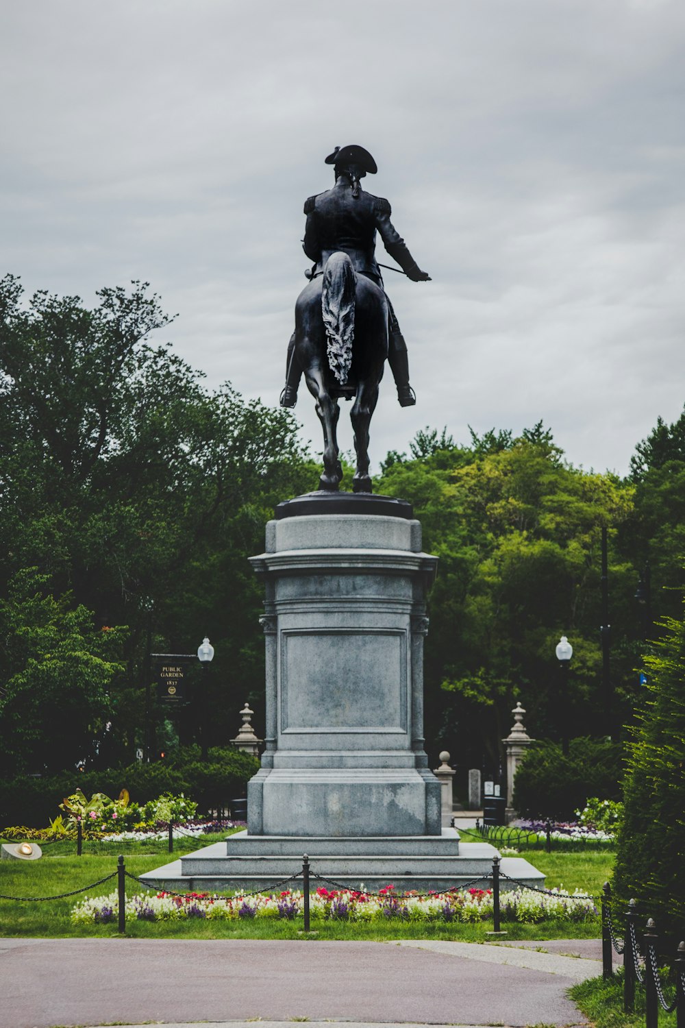 black statue of man on top of gray concrete post