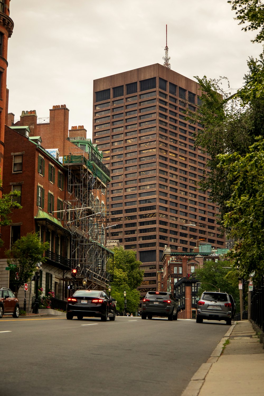 cars parked in front of brown building during daytime