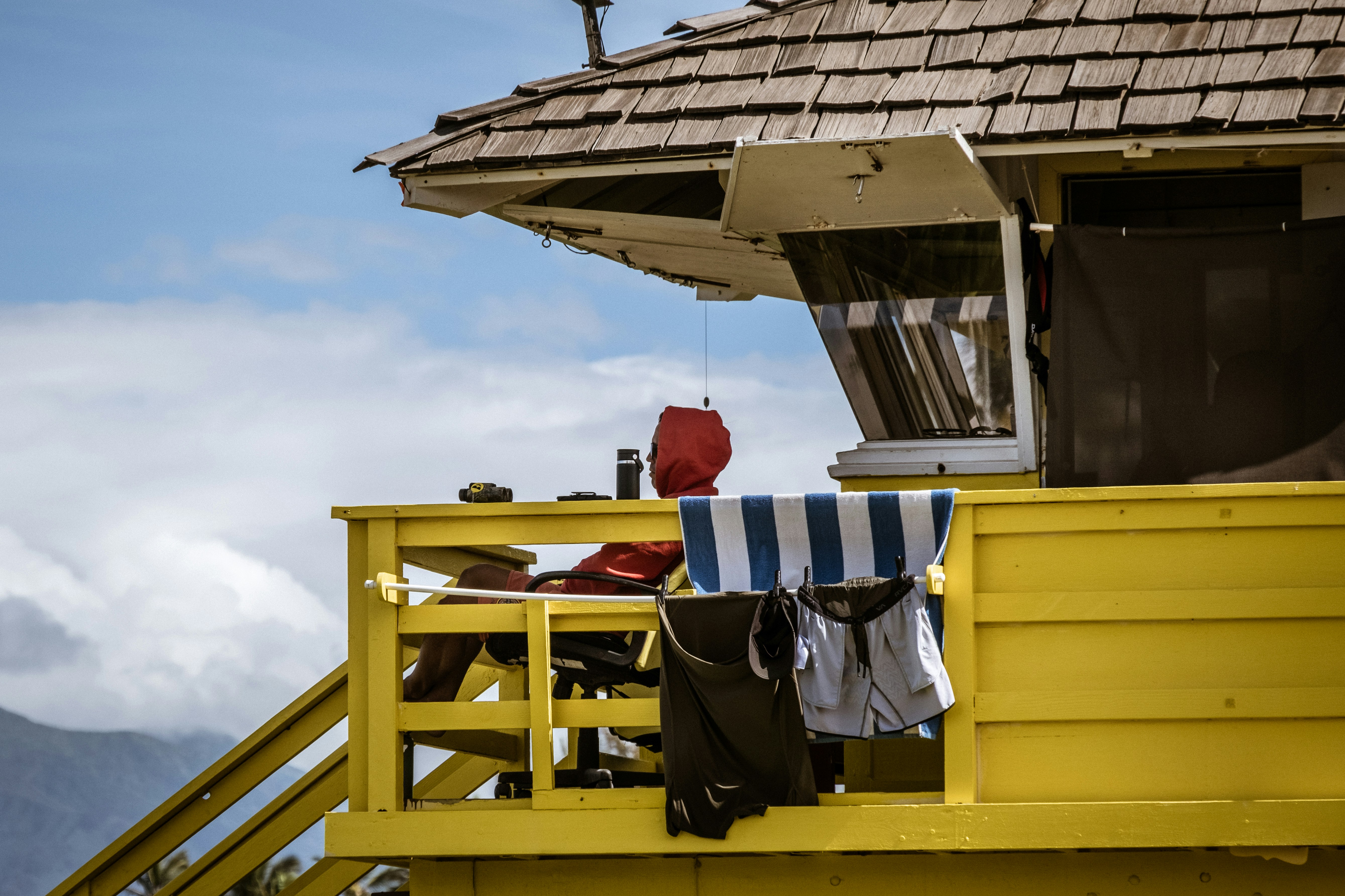 black and white textile on yellow wooden ladder, 