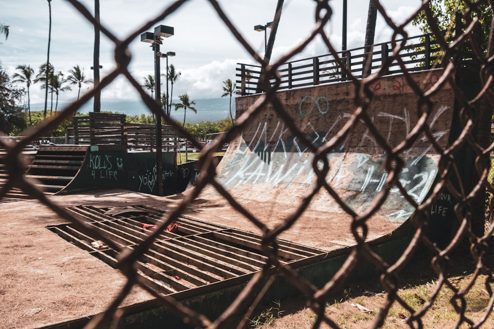 brown metal fence near body of water during daytime