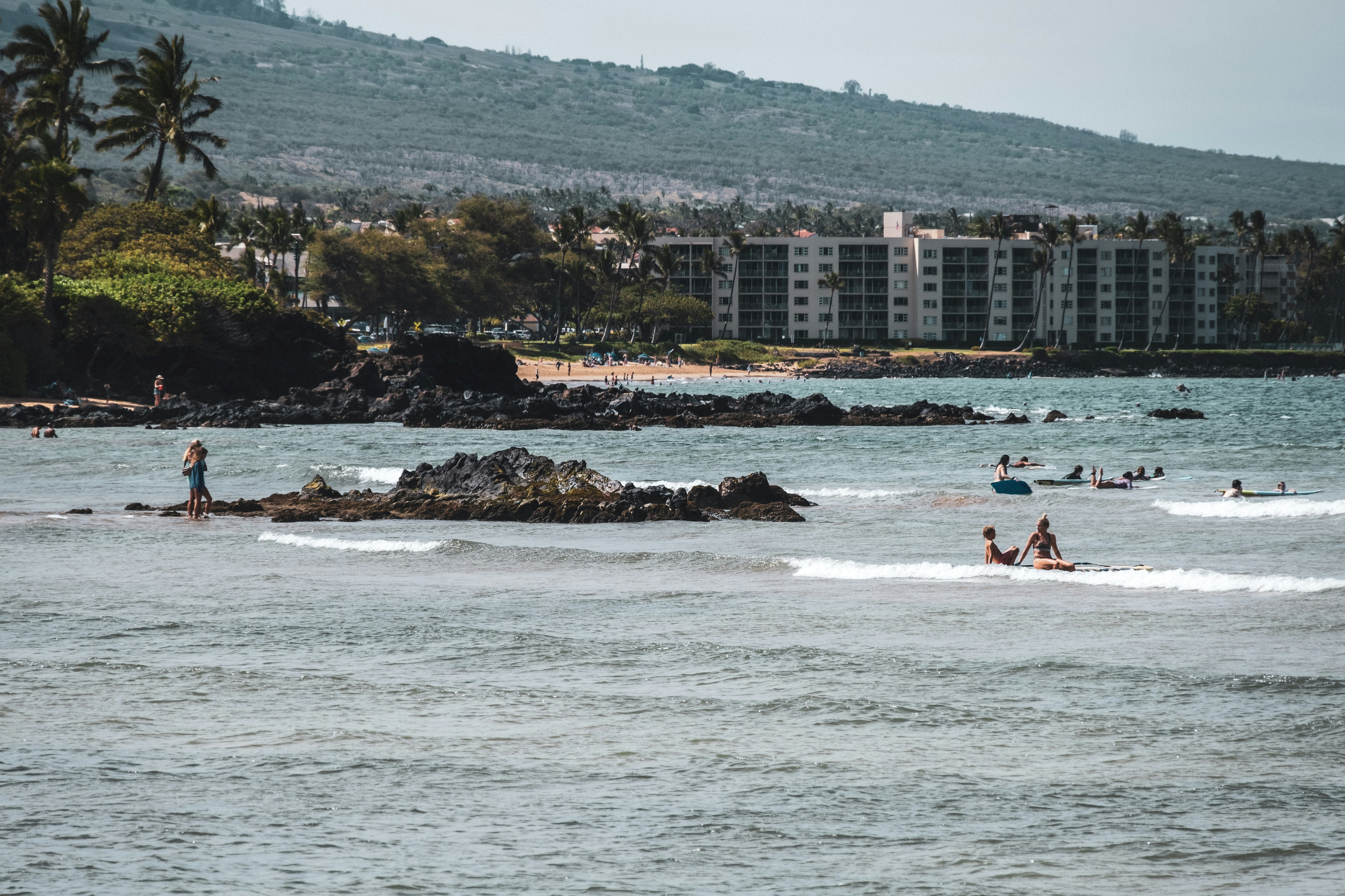 people surfing on sea during daytime