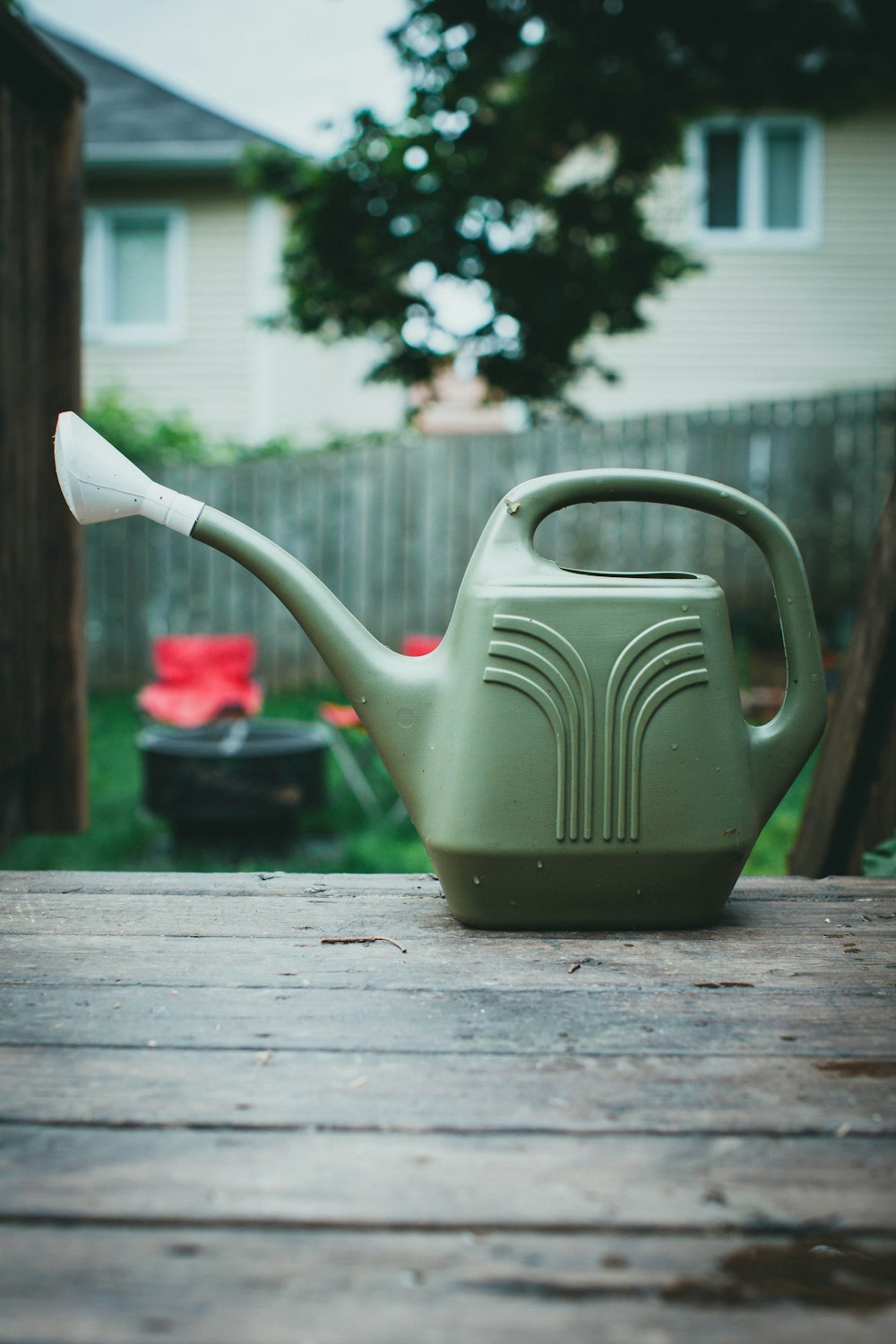 black watering can on brown wooden table