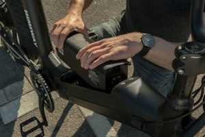A happy rider connecting a portable bike charger before a morning ride