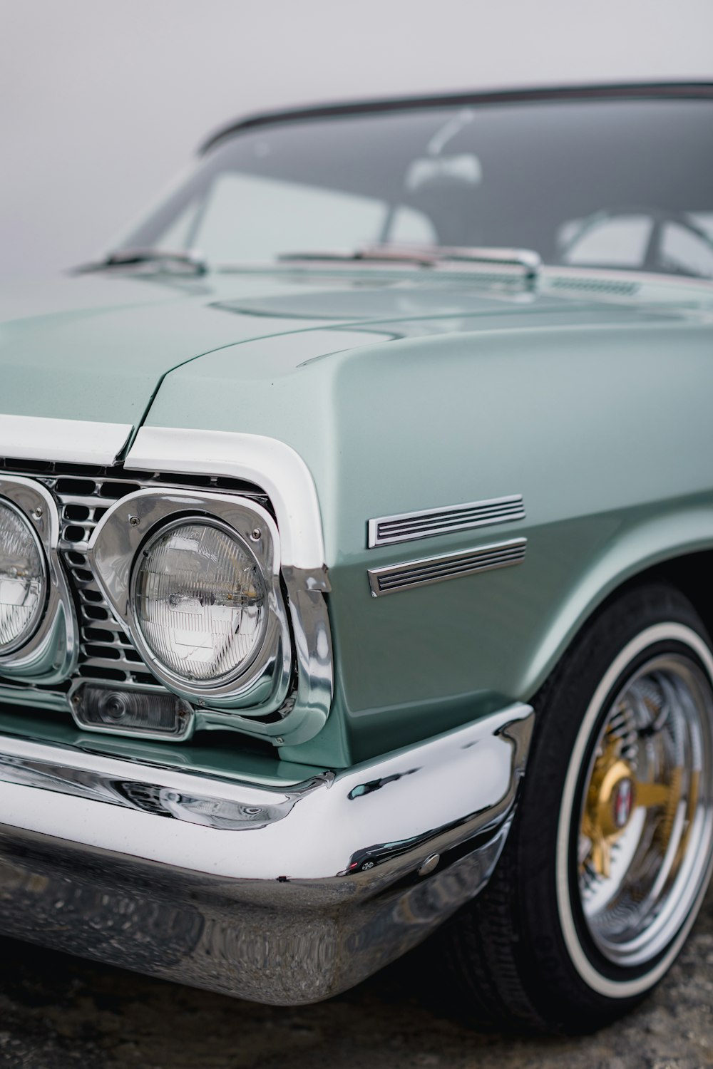 teal car with chrome front wheel