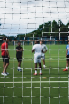 group of people playing soccer during daytime