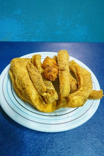 A platter of blackened catfish served with sides.