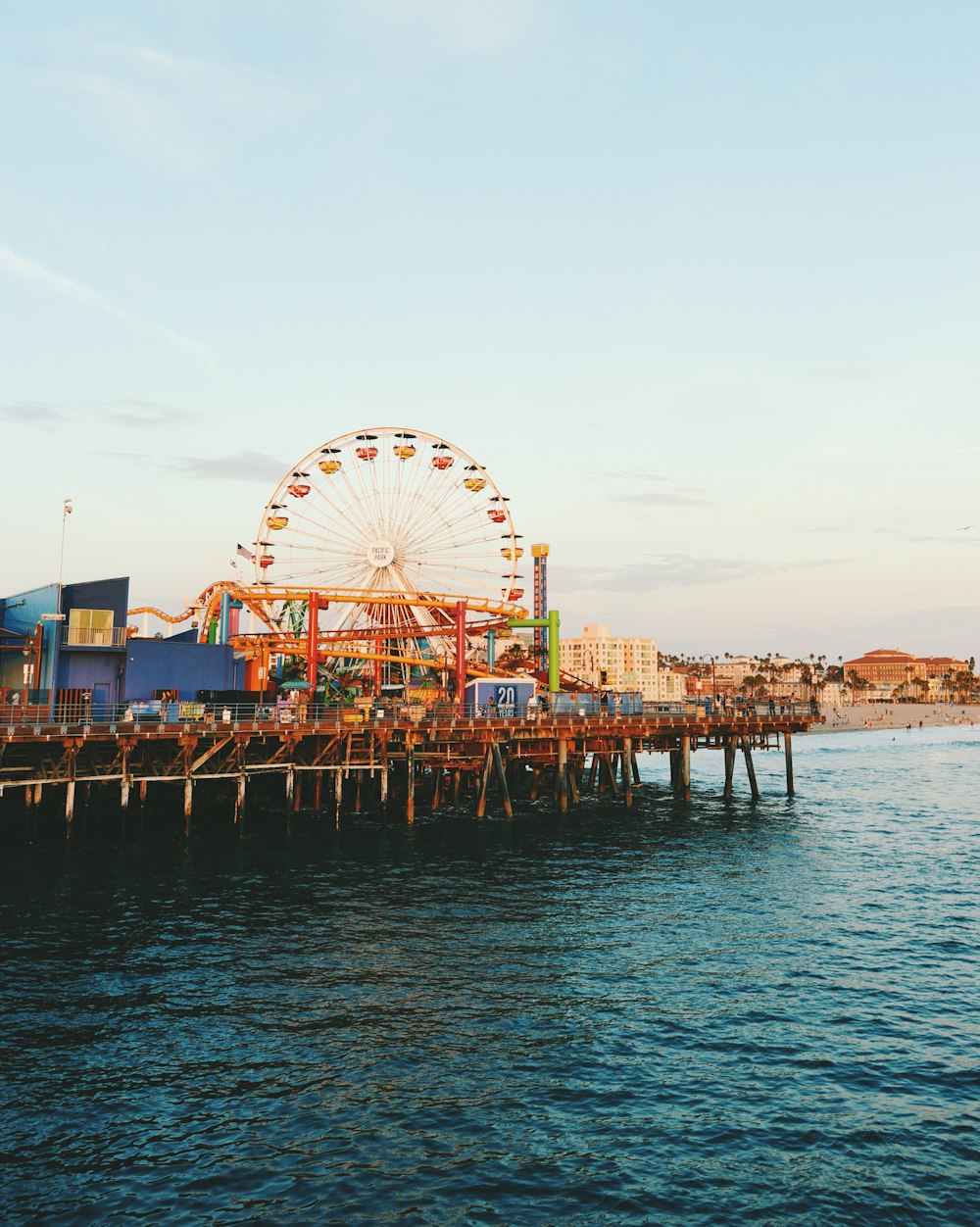 ferris wheel near body of water during daytime