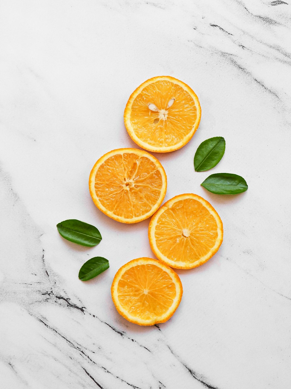 sliced orange fruit on white table