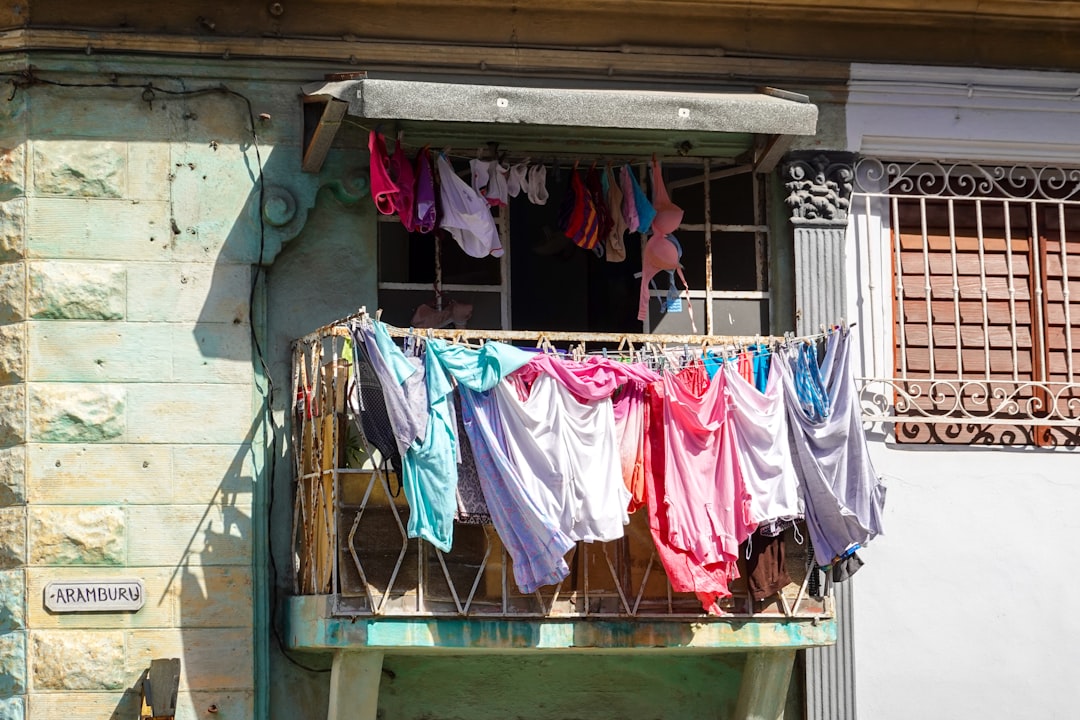 clothes hanged on green metal rack