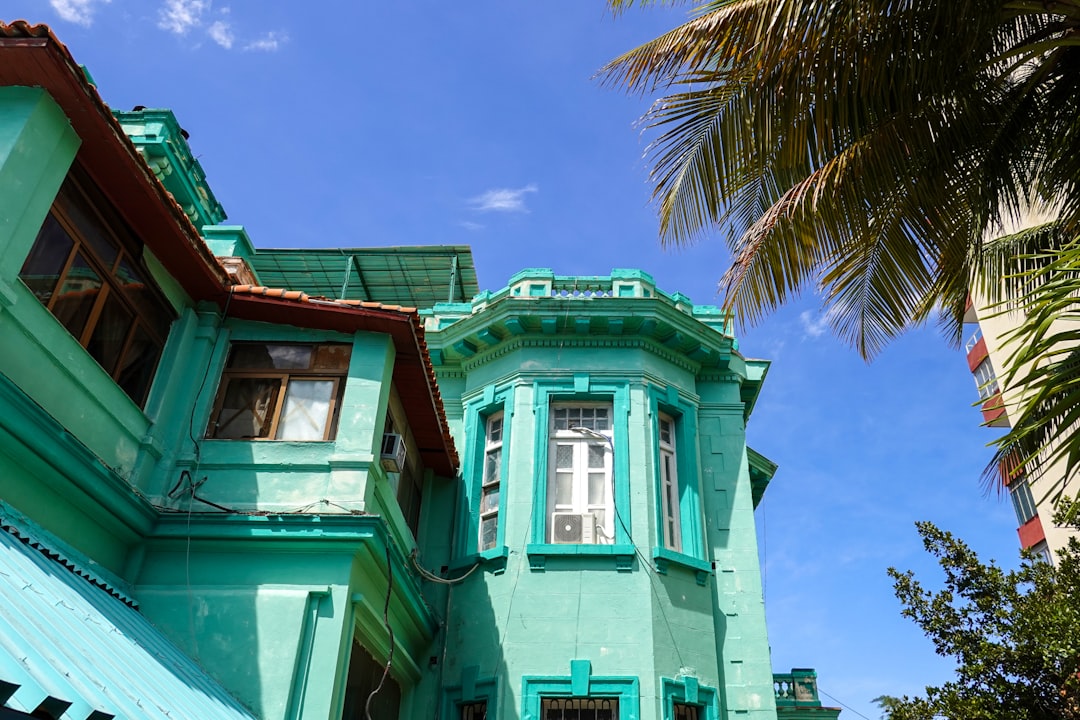 green and brown concrete building under blue sky during daytime