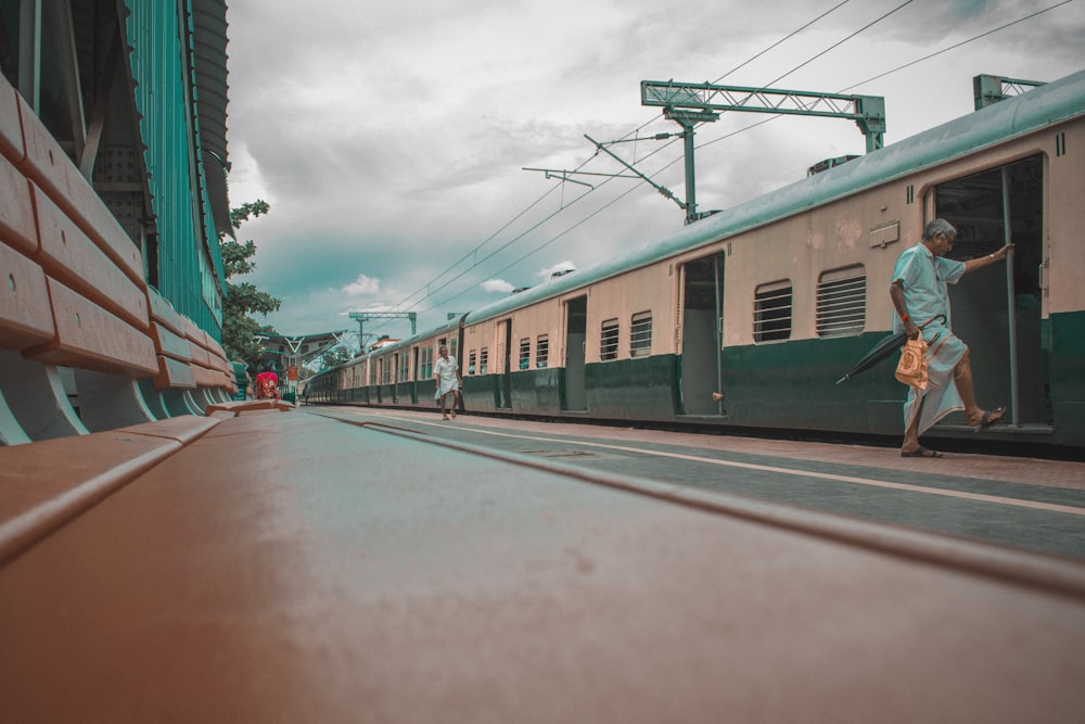 gray and blue train under gray sky