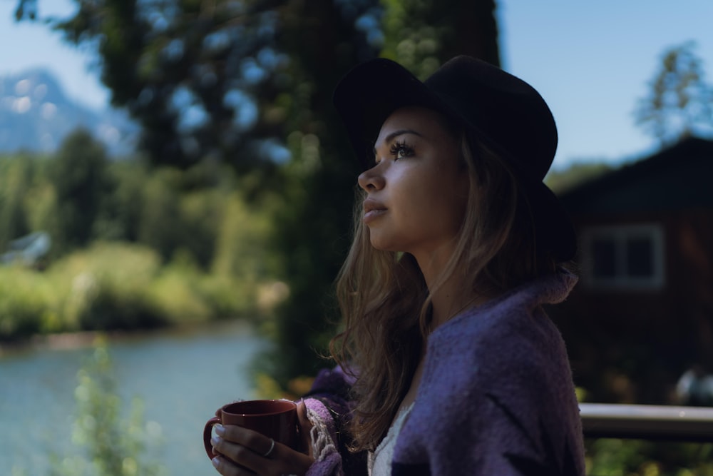 woman in black hat and purple coat