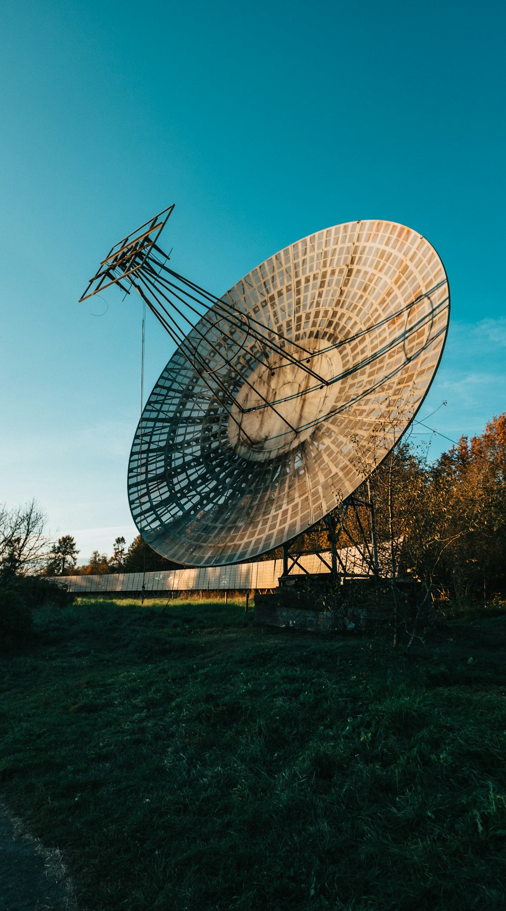 gray satellite dish on green grass field during daytime