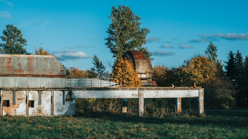 brown and white concrete building near trees under blue sky during daytime