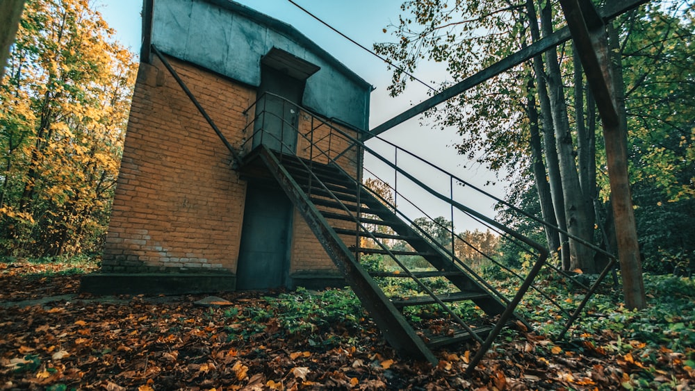 brown brick building with black metal railings