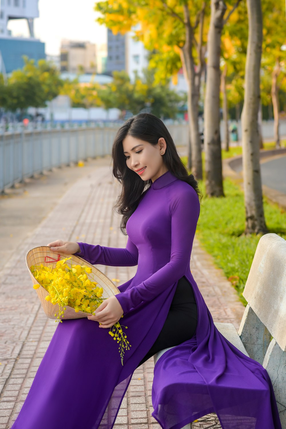 woman in purple long sleeve dress sitting on concrete bench during daytime