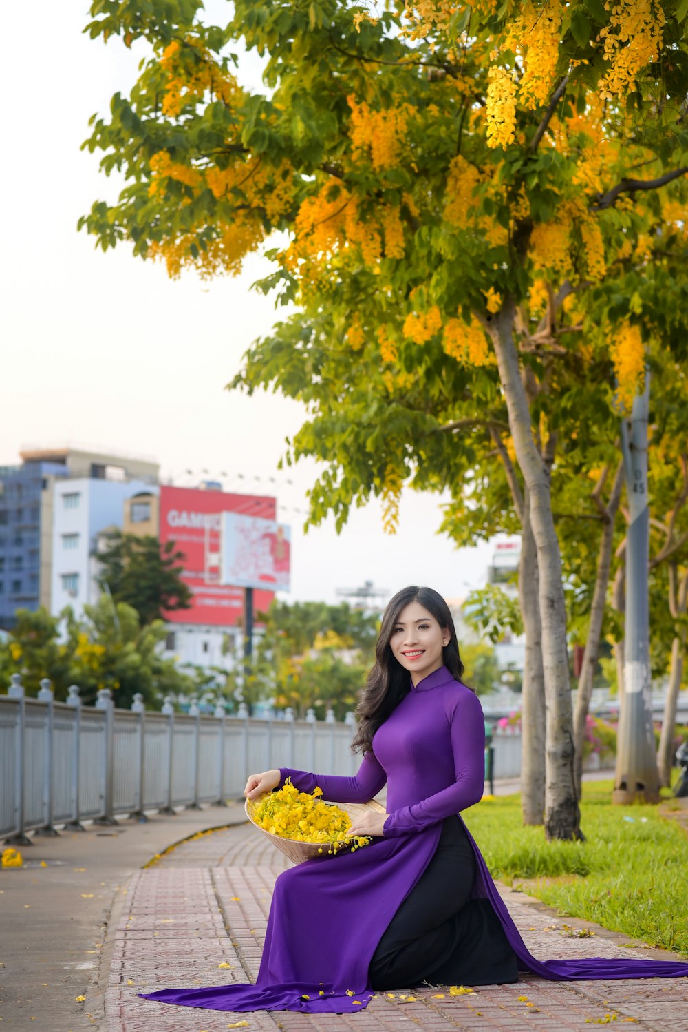 woman in purple long sleeve shirt standing under tree during daytime