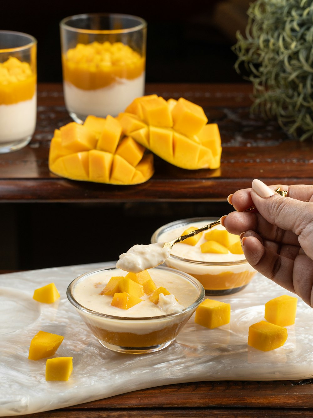 person holding sliced fruit on white ceramic bowl