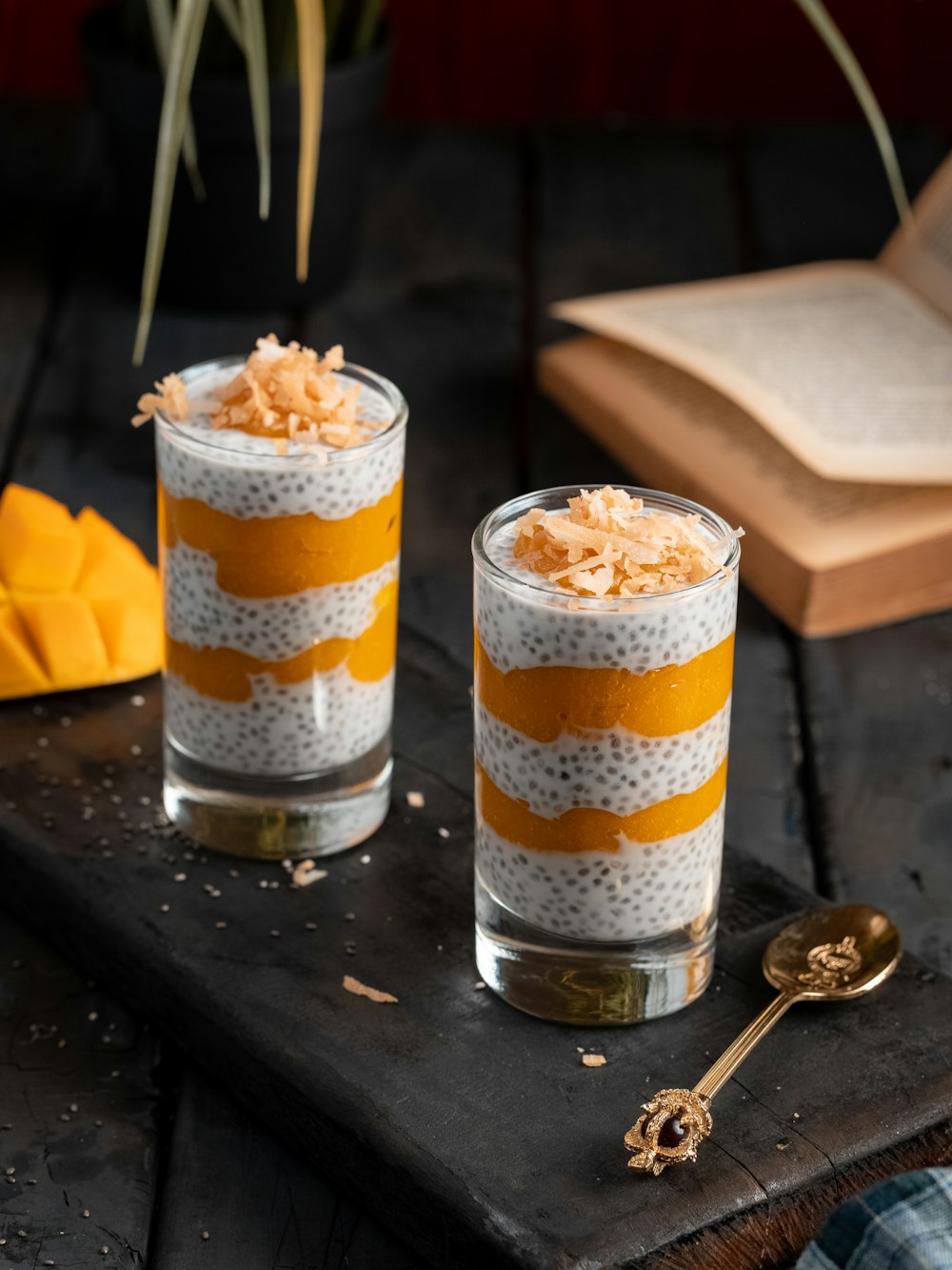 clear drinking glass with ice cream on black wooden table