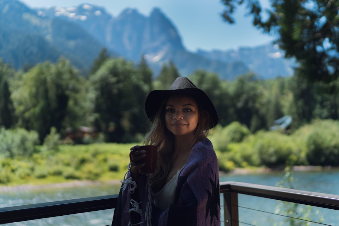 woman in black hat and brown jacket