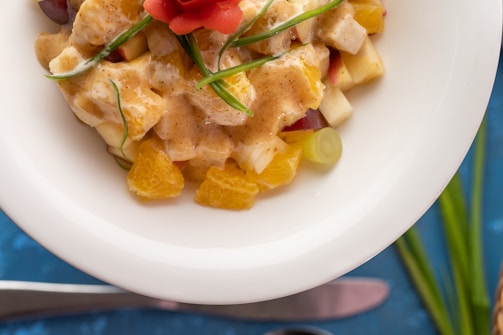 A close-up of a colorful fruit salad in a glass bowl.