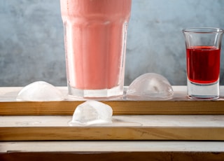 pink liquid in clear drinking glass