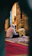 A warm, inviting photo of a customer reading an Islamic book in a cozy nook.