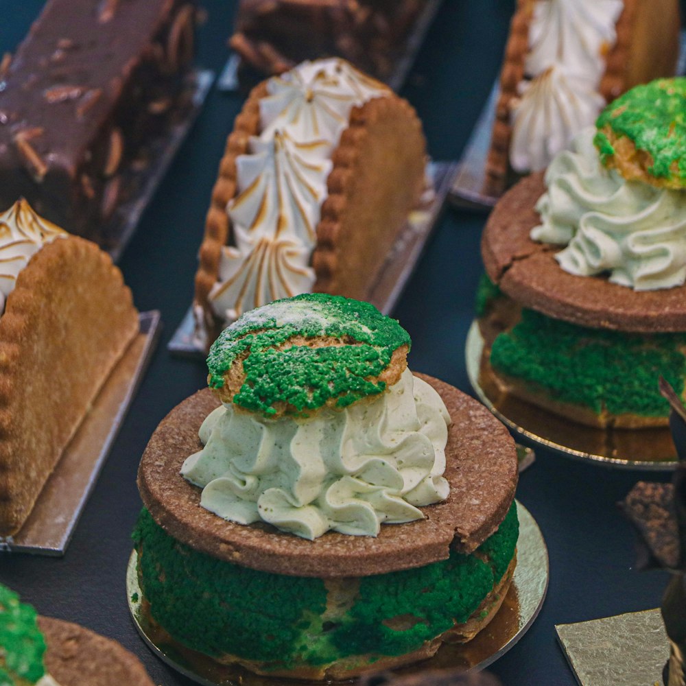 brown and green cake with white icing on top