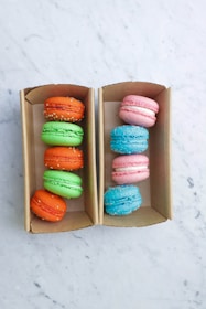 pink blue and yellow macaroons in box