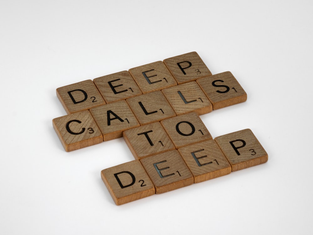 brown wooden puzzle blocks on white surface