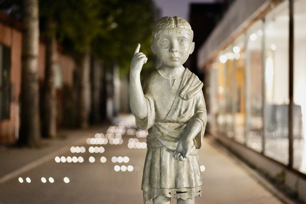 woman holding heart statue during night time