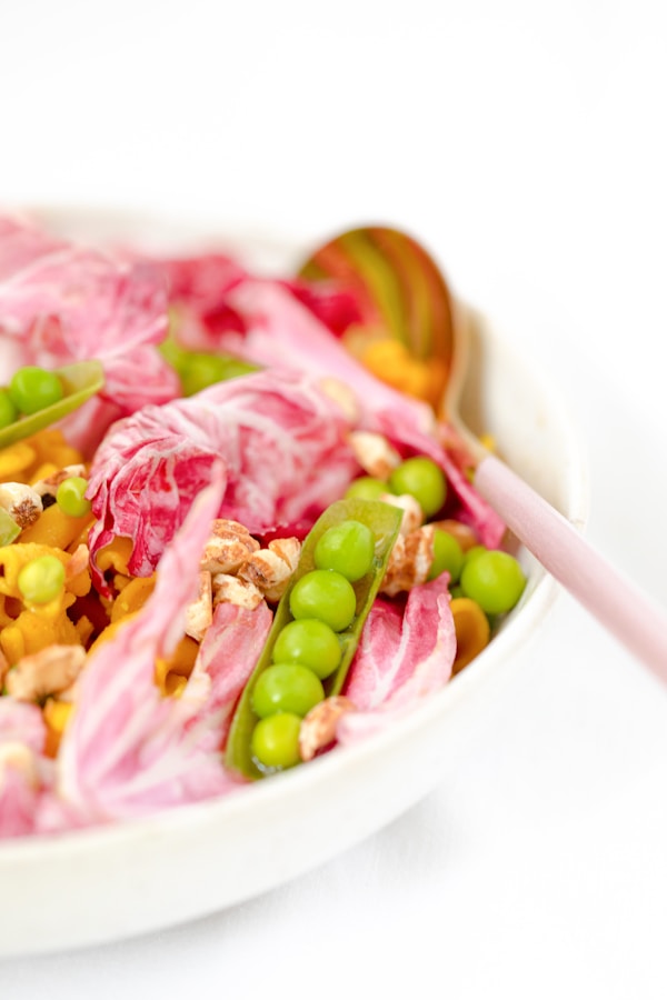 Green beans and meat on white ceramic bowl