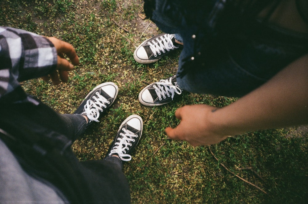 person wearing black and white converse all star low top sneakers