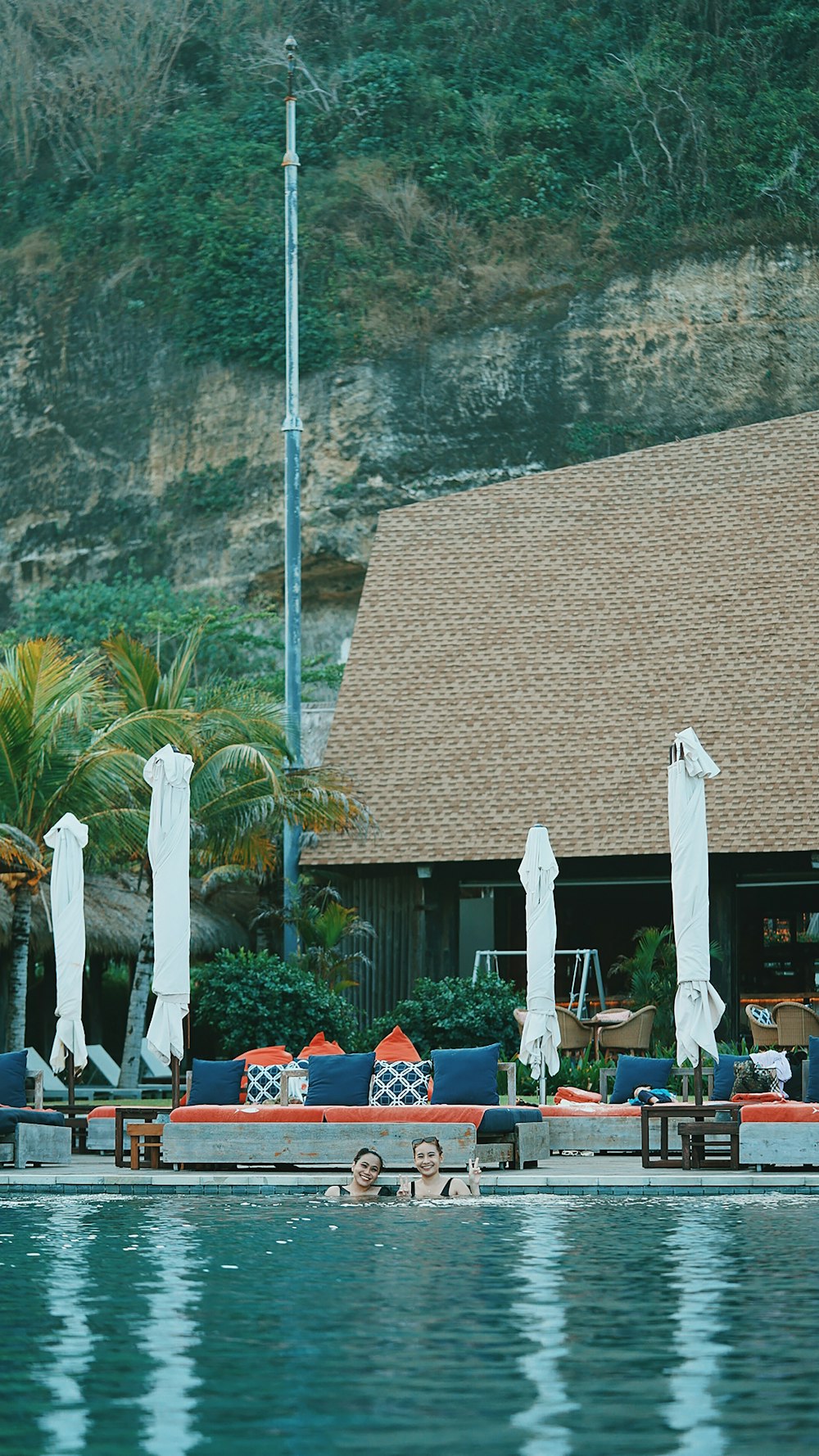 people sitting on chairs near brown concrete building during daytime