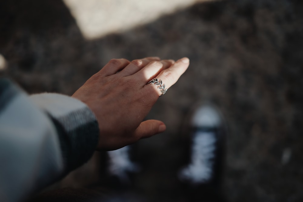 person wearing silver diamond ring