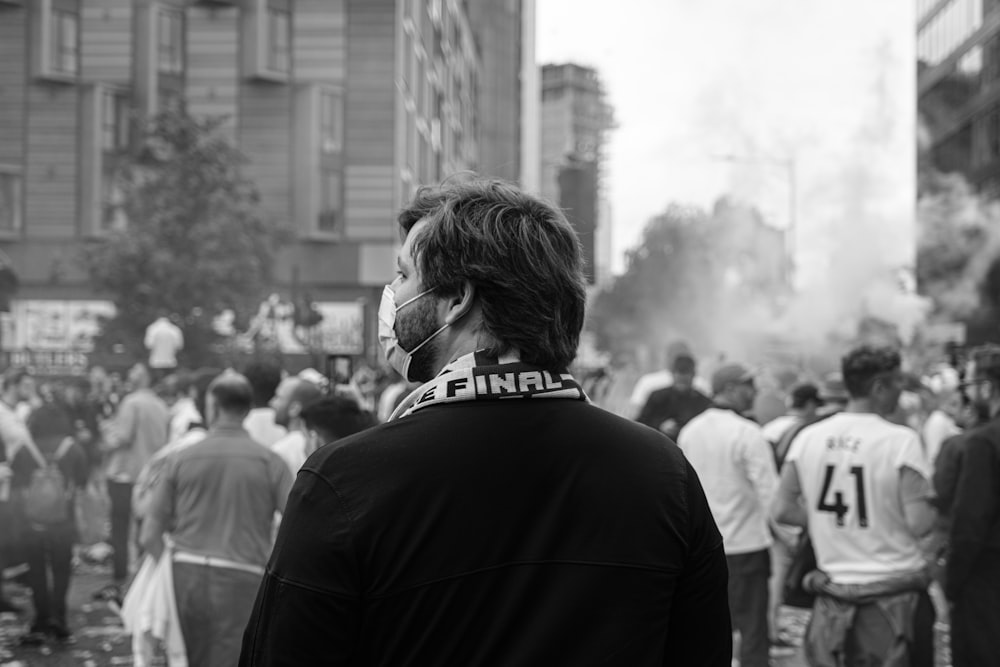 grayscale photo of man in black suit