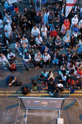 Audience watching a film screening at a cultural festival with expressions of awe and joy.