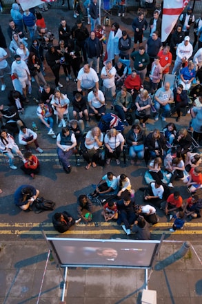 A diverse group of people enjoying an outdoor community sports event in London.