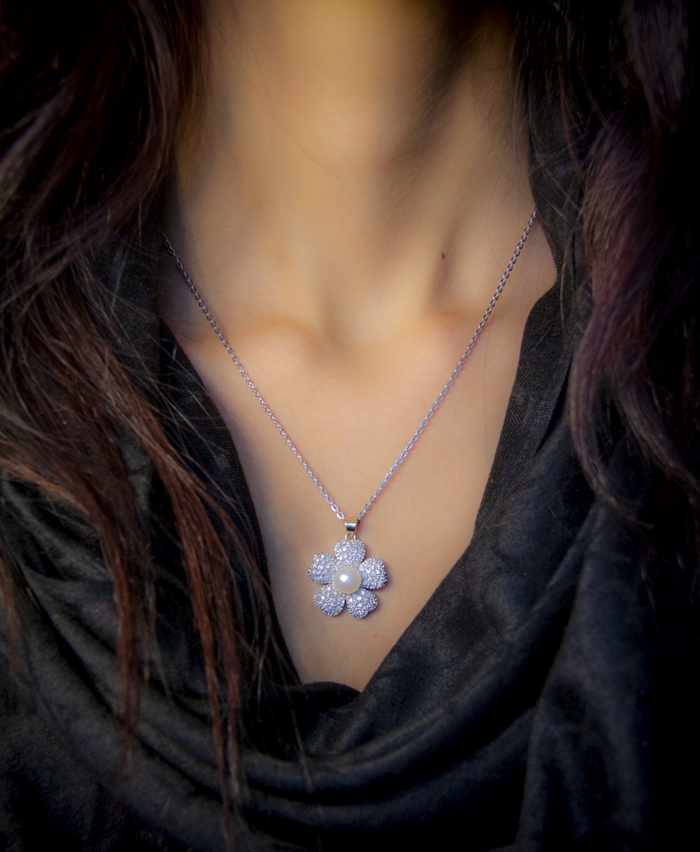 woman in black v neck shirt wearing silver necklace