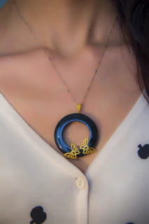 woman wearing blue and silver necklace