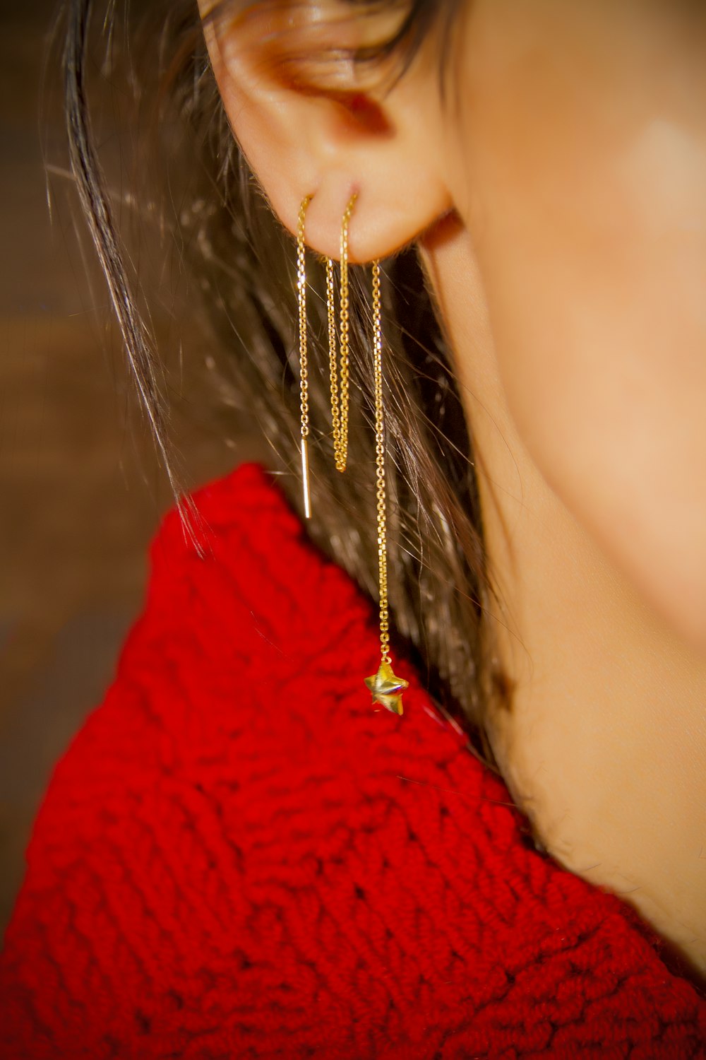 woman in red shirt wearing gold necklace