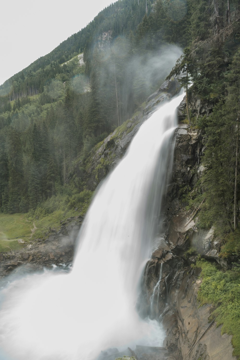 waterfalls on green grass covered mountain during daytime